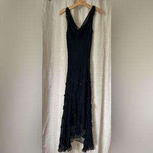 Beautiful elegant dress with embellishments on shoulders and front of dress.